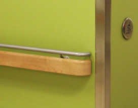 A green wall in a bathroom protected by PVC Corner & Wall Guard Protection Solutions from Warrior WPS.