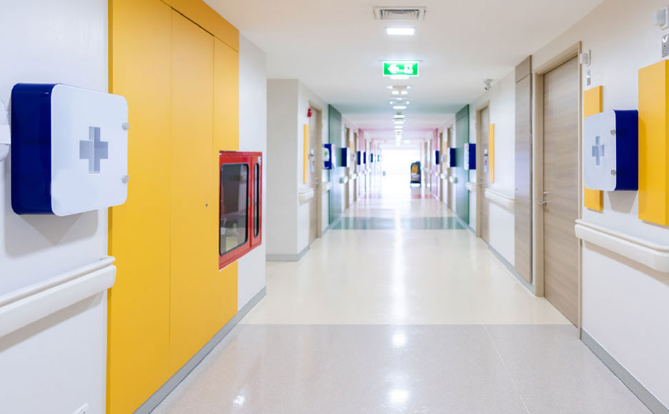 A hallway in a hospital with colorful walls.