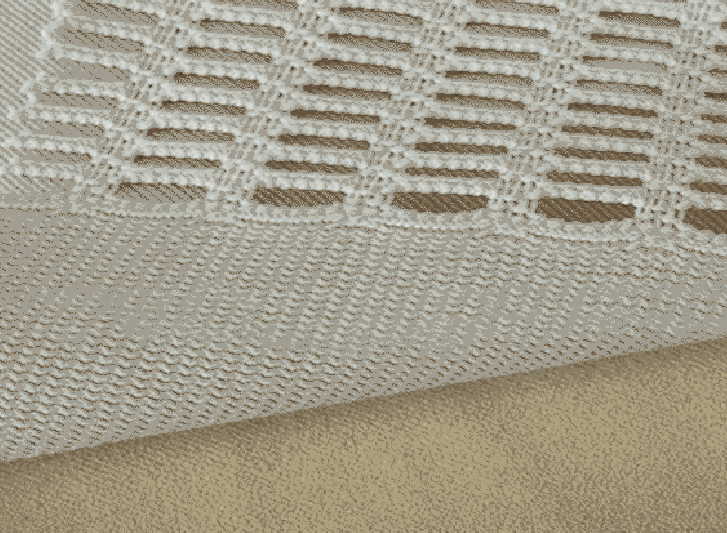 A white blanket on a tan background, giving off a clean and cozy vibe.